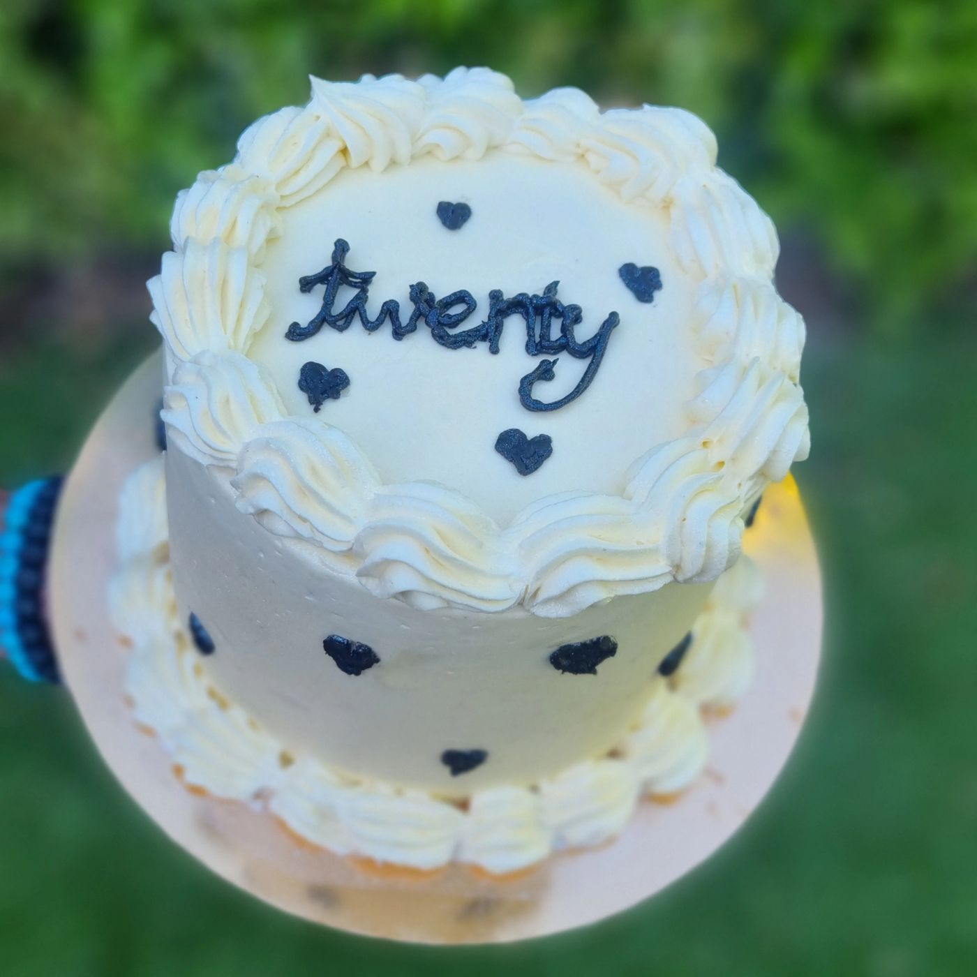 A blue and white twenty cake with piped hearts
